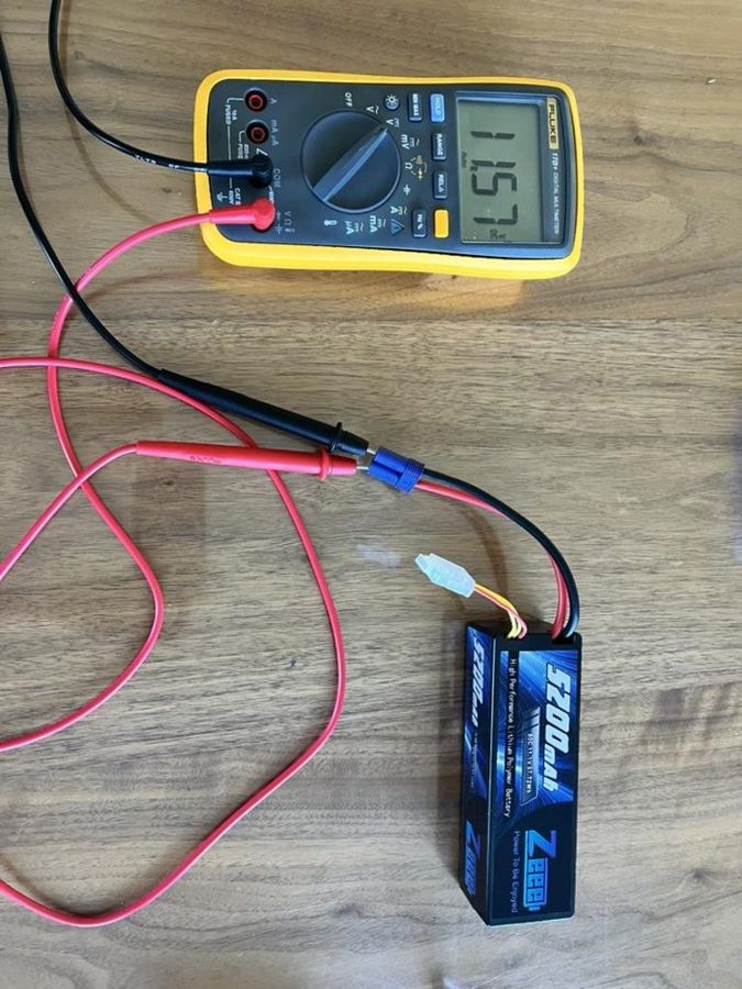 A multimeter measuring a robot battery
